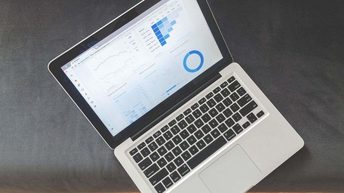 Printed analytics charts and graphs spread across a desk.