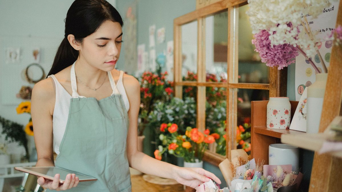 A small business owner photographing a product with a phone.