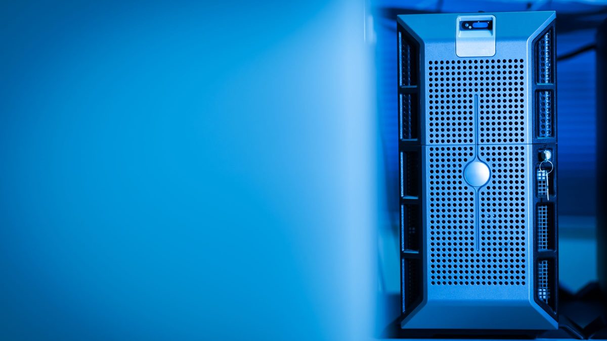 Server racks lit by blue indicator lights in a data center aisle.