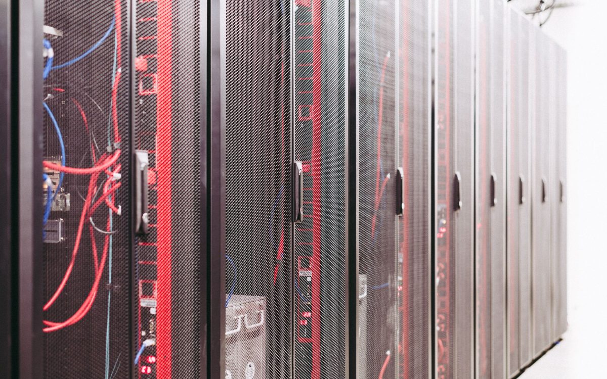 Rows of networking equipment and cabling inside a data center.